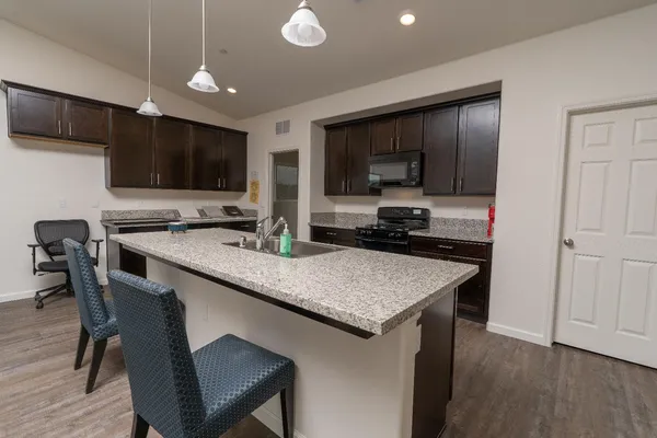 a kitchen with a stove a sink and a refrigerator