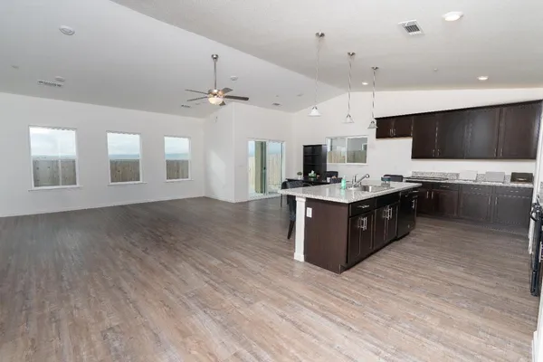 a large kitchen with stainless steel appliances granite countertop a stove and a sink