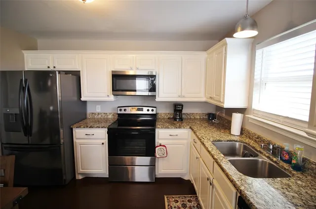 a kitchen with a refrigerator stove and sink
