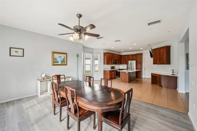 a dining room with furniture and wooden floor