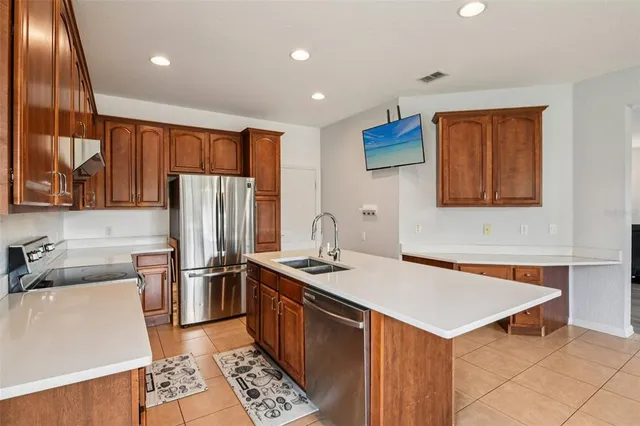 a kitchen with stainless steel appliances granite countertop a sink stove and refrigerator