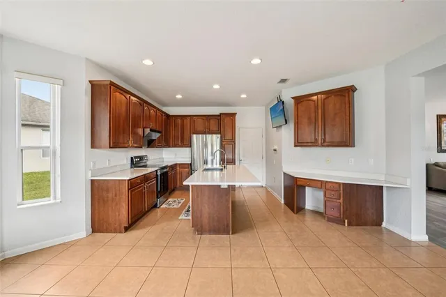 a large kitchen with stainless steel appliances lots of counter top space