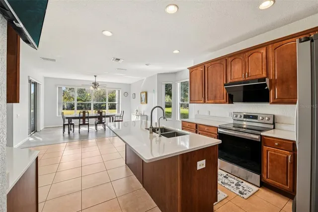 a kitchen with stainless steel appliances granite countertop a sink stove and cabinets
