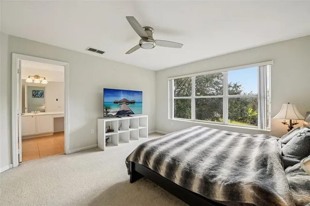 a bedroom with a large bed and a window