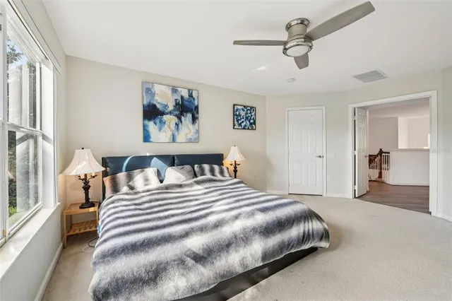 a bedroom with a large bed and a chandelier