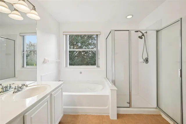 a bathroom with a bathtub a sink and a shower