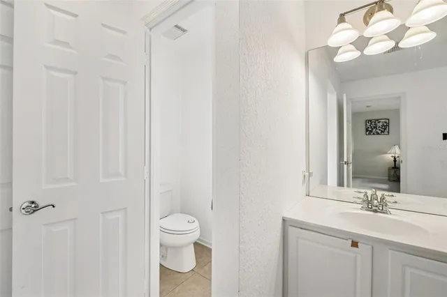 a bathroom with a toilet a sink and a mirror