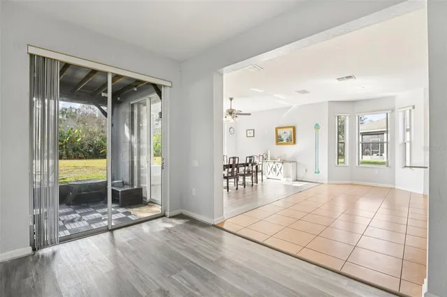 an empty room with floor to ceiling windows and painted walls