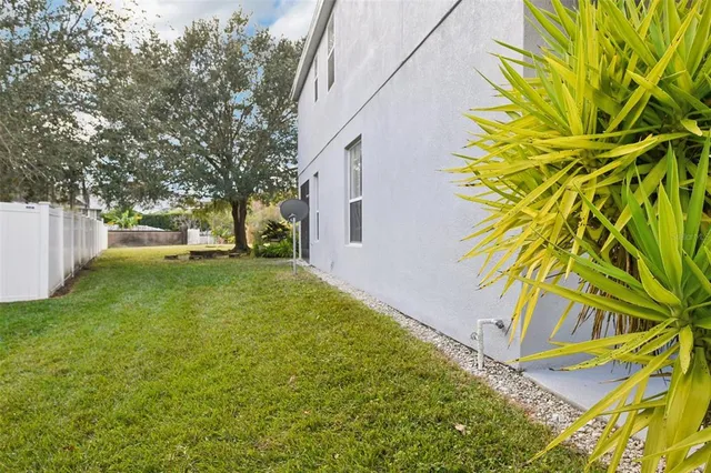 a view of a roof deck with wooden fence and a floor to ceiling window