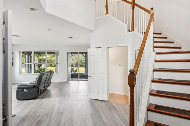 a view of entryway and hall with wooden floor