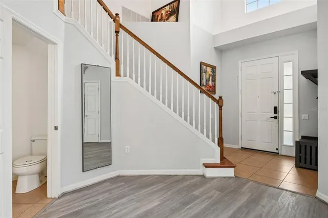 a view of entryway with wooden floor and stairs