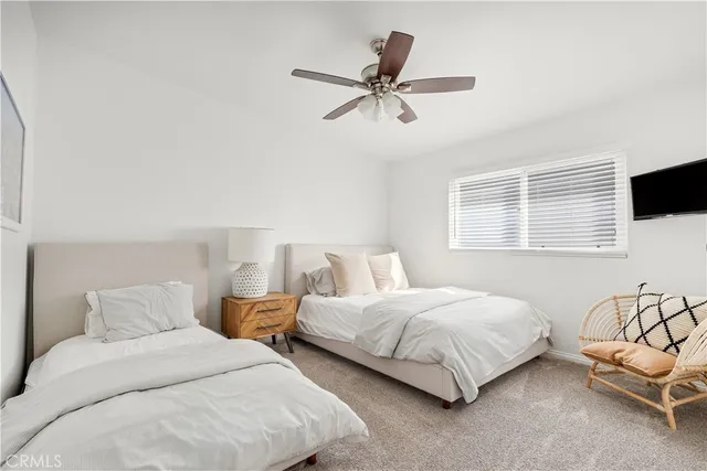 a bedroom with two beds and a table