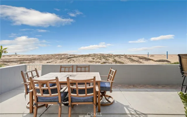 a view of a patio with chairs and potted plants