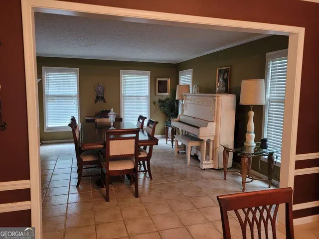 a dining room with furniture and wooden floor