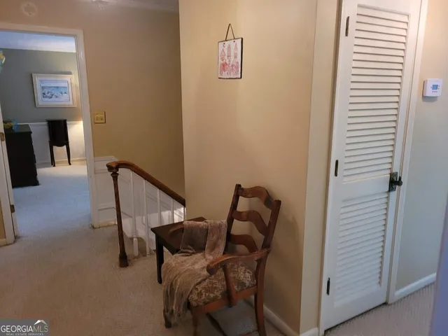 a bedroom with a bed and dresser with mirror