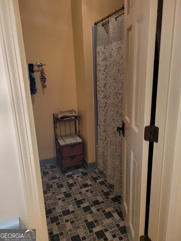 a bathroom with a toilet and a shower curtain