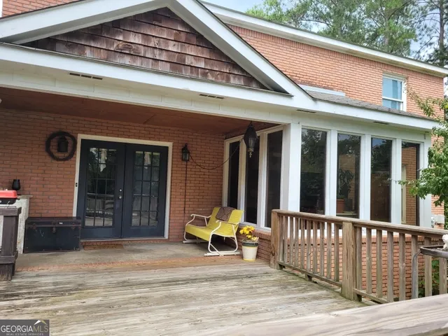 a view of house with deck and outdoor space