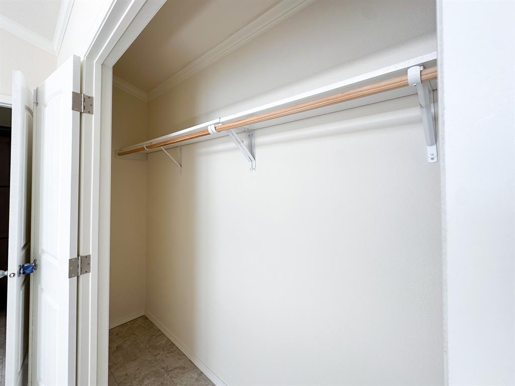 153 Cabrera Street Oak Point, TX 75068 - Photo 7 of 22 Interior closet featuring a single hanging rod, upper shelf, and tile flooring
