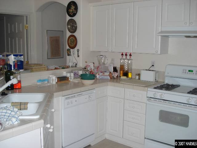 10285 Lucente Way Reno, NV 89521 - Photo 8 of 9 a kitchen with white cabinets and sink