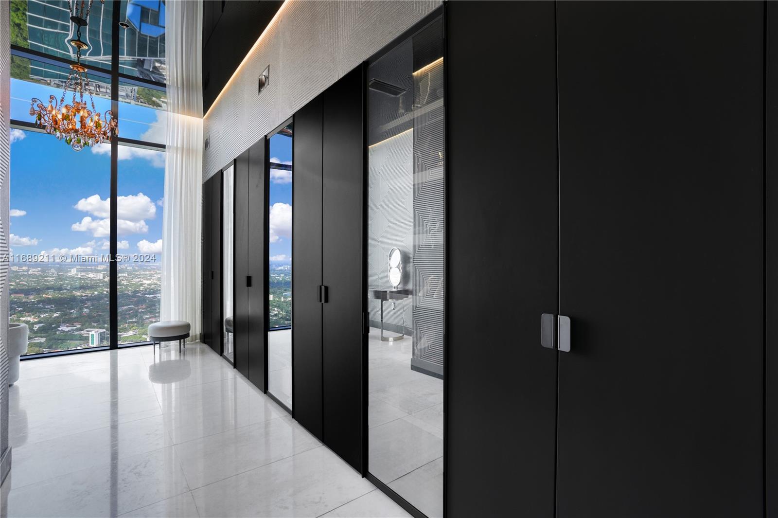 1451 Brickell Avenue, Unit PH54 Miami, FL 33131 - Photo 13 of 36 a view of a glass door and a living room