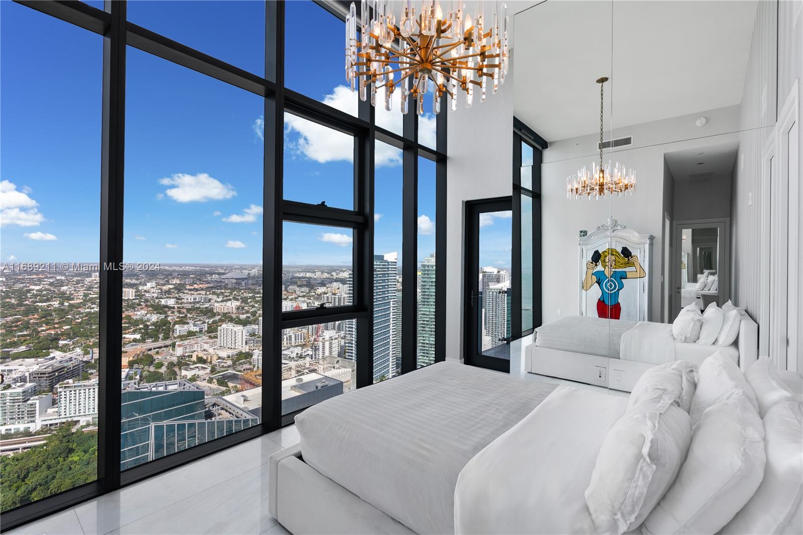 1451 Brickell Avenue, Unit PH54 Miami, FL 33131 - Photo 16 of 36 a bed sitting in a balcony next to a large window