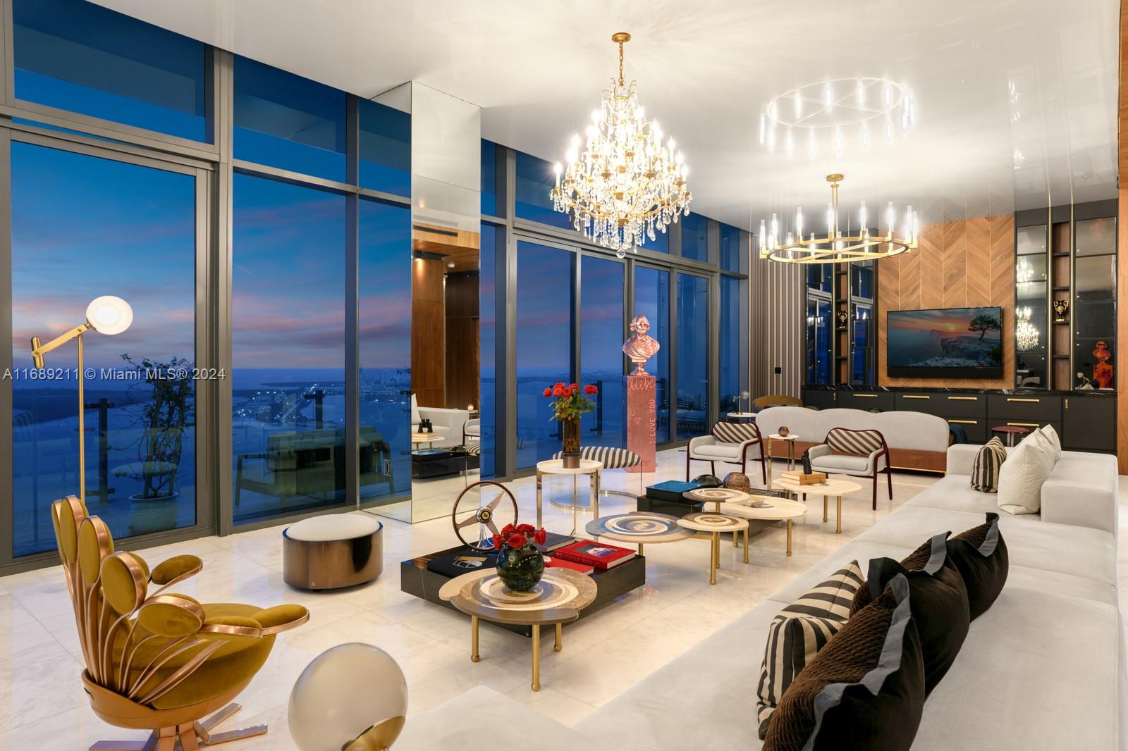 1451 Brickell Avenue, Unit PH54 Miami, FL 33131 - Photo 26 of 36 a living room with furniture and chandelier