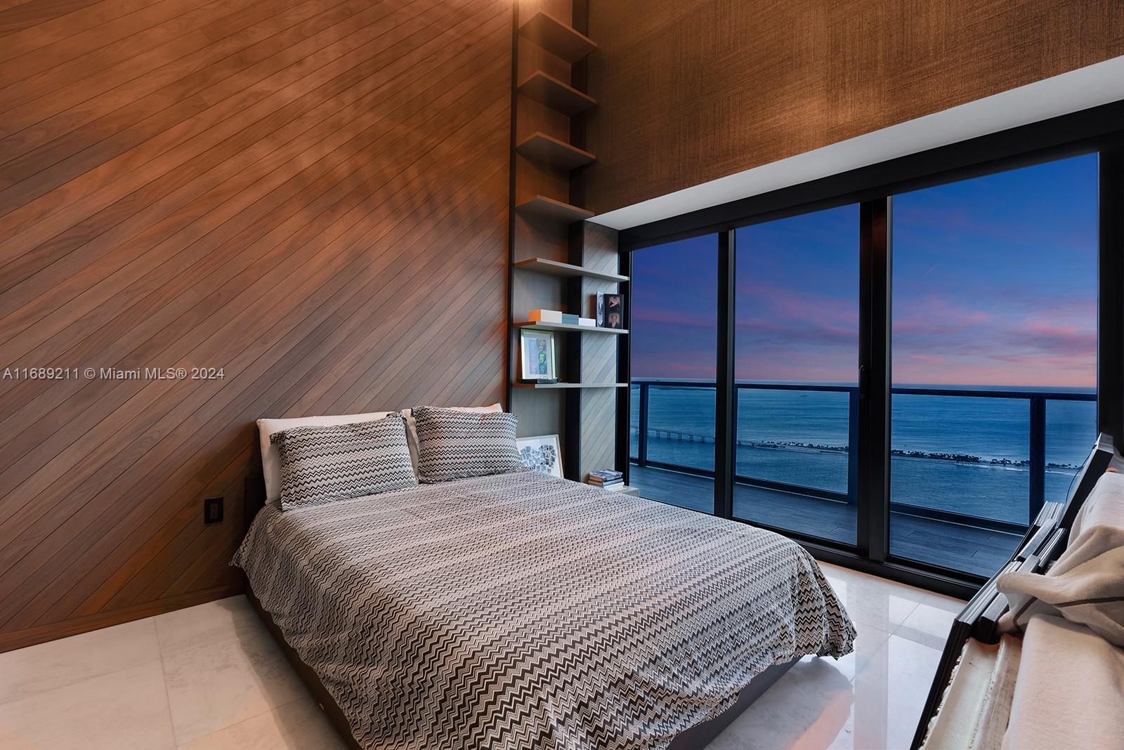 1451 Brickell Avenue, Unit PH54 Miami, FL 33131 - Photo 34 of 36 a bedroom with a bed and a cabinets