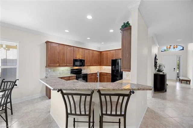 a large kitchen with a table and chairs