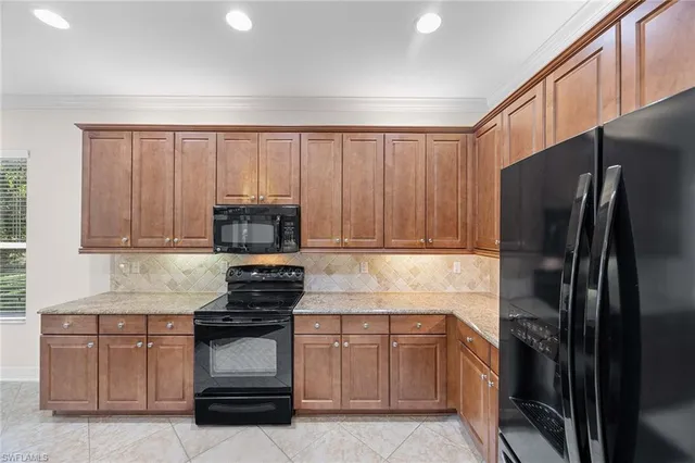 a kitchen with a refrigerator stove and cabinets