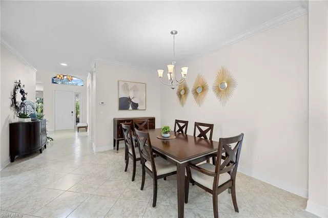 a view of a dining room with furniture and chandelier