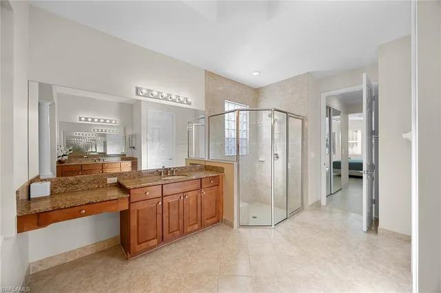 a large bathroom with a large mirror vanity and shower