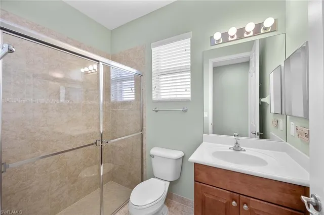 a bathroom with a sink toilet a mirror and shower