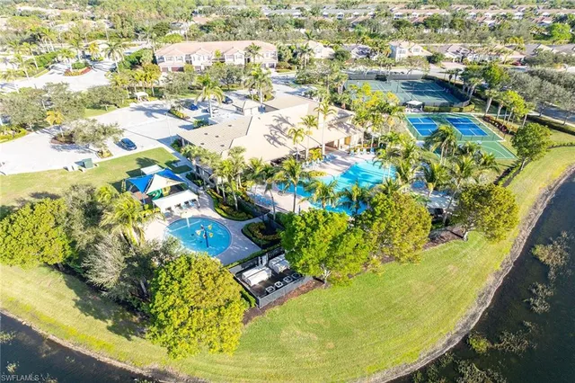 a view of a swimming pool with a yard and plants