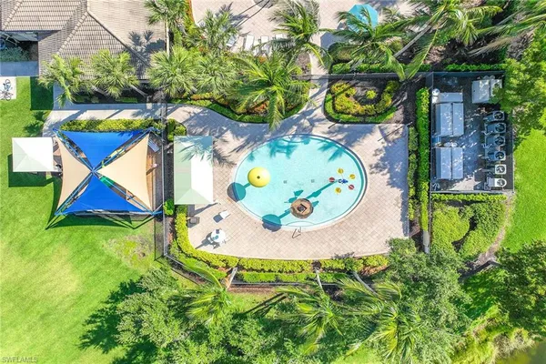 a blue swimming pool with a garden and plants