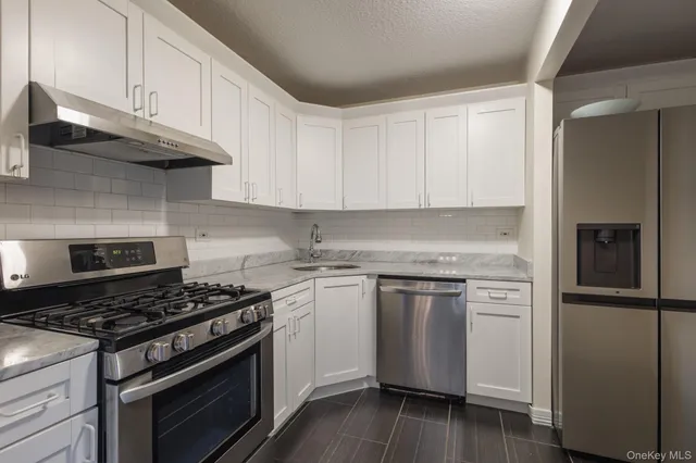 a kitchen with a stove and a refrigerator