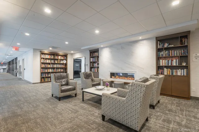 a room with gym equipment and furniture