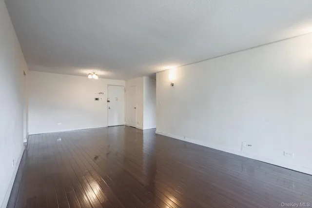an empty room with wooden floor