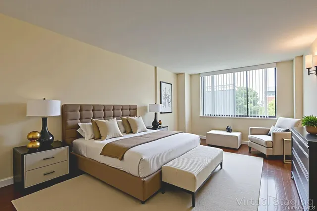 a spacious bedroom with a bed and wooden floor