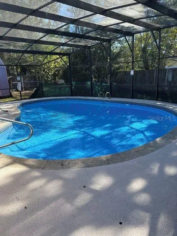 a view of a swimming pool with a patio