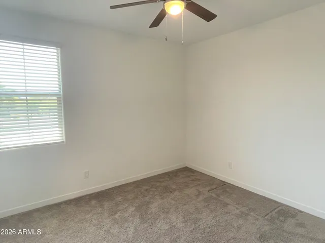 an empty room with closet and mirror