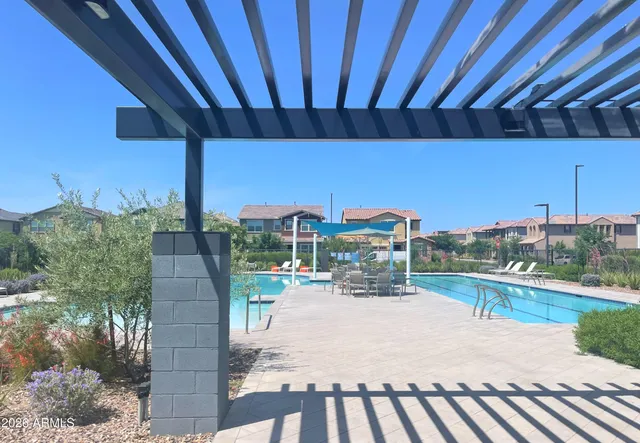 an aerial view of residential houses with outdoor space and lake view
