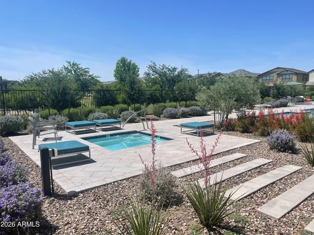 an aerial view of a house with a garden and lake view
