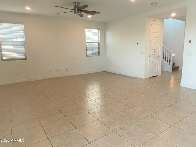 an empty room with a bathroom and a window