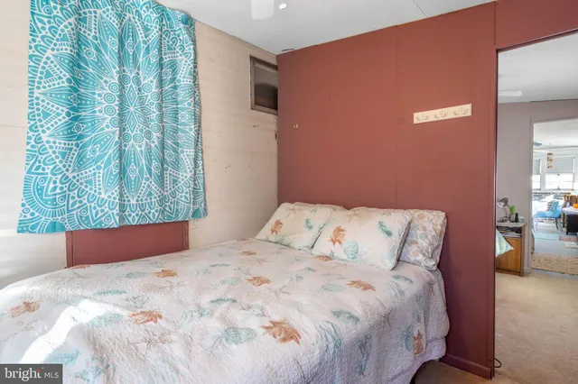 a bedroom with a bed and window