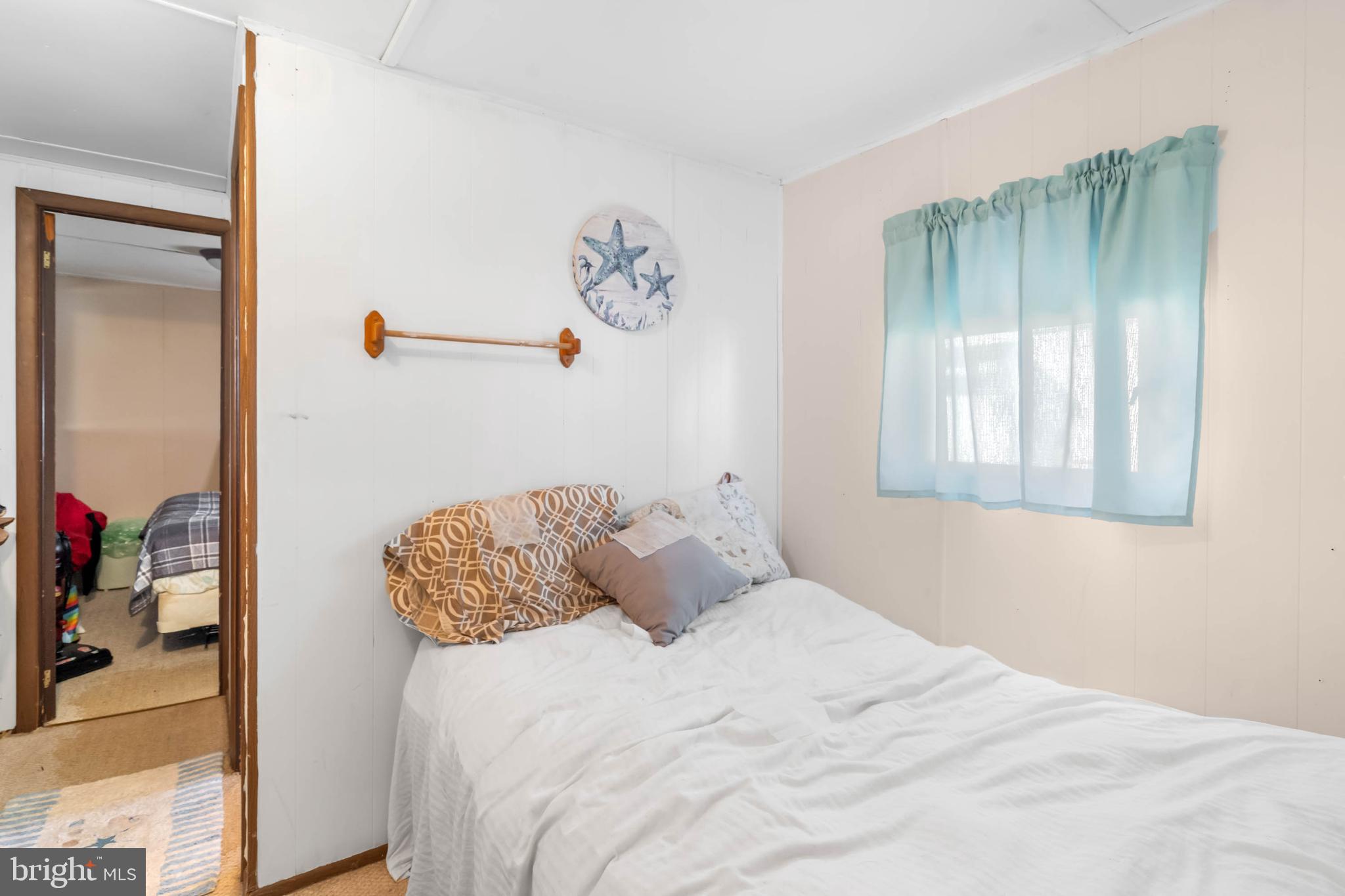 11451 Gum Point Road, Unit 17 Berlin, MD 21811 - Photo 18 of 21 a bedroom with a bed and a window