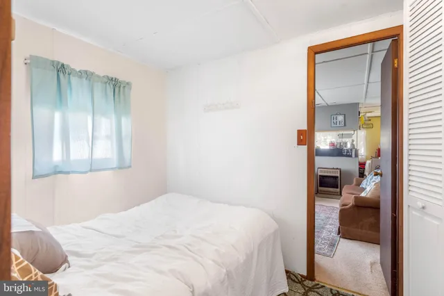 a bedroom with a bed and bathroom