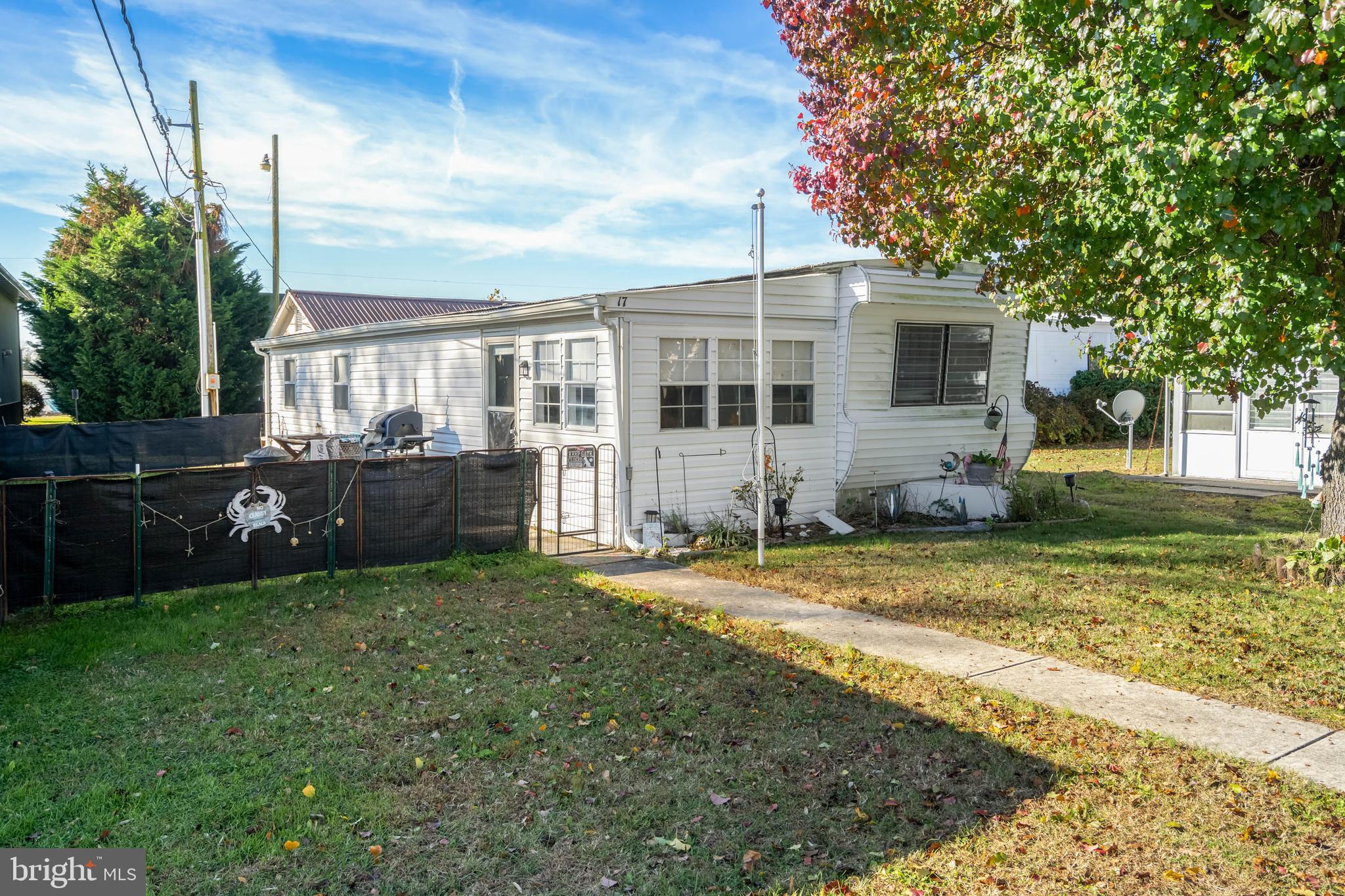 11451 Gum Point Road, Unit 17 Berlin, MD 21811 - Photo 2 of 21 a view of a house with a yard and plants