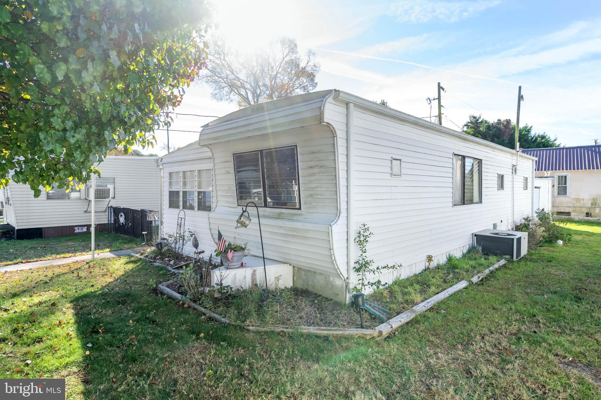 11451 Gum Point Road, Unit 17 Berlin, MD 21811 - Photo 4 of 21 a front view of a house with a yard