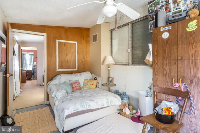 a bedroom with a bed and a couch