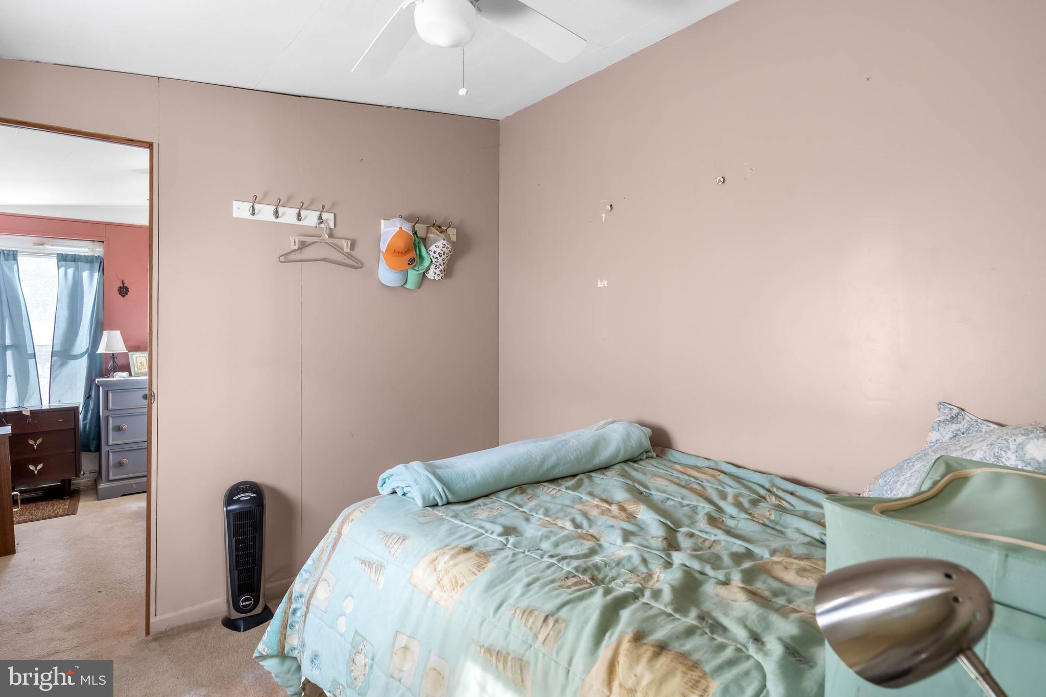 11451 Gum Point Road, Unit 17 Berlin, MD 21811 - Photo 9 of 21 a bedroom with a bed and a chandelier